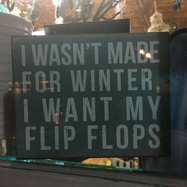 Sign reading "I wasn't made for winter, I want my flip flops"