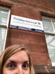 Tired selfie at the Paisley Gilmour Station, with signage translated into Gaelic