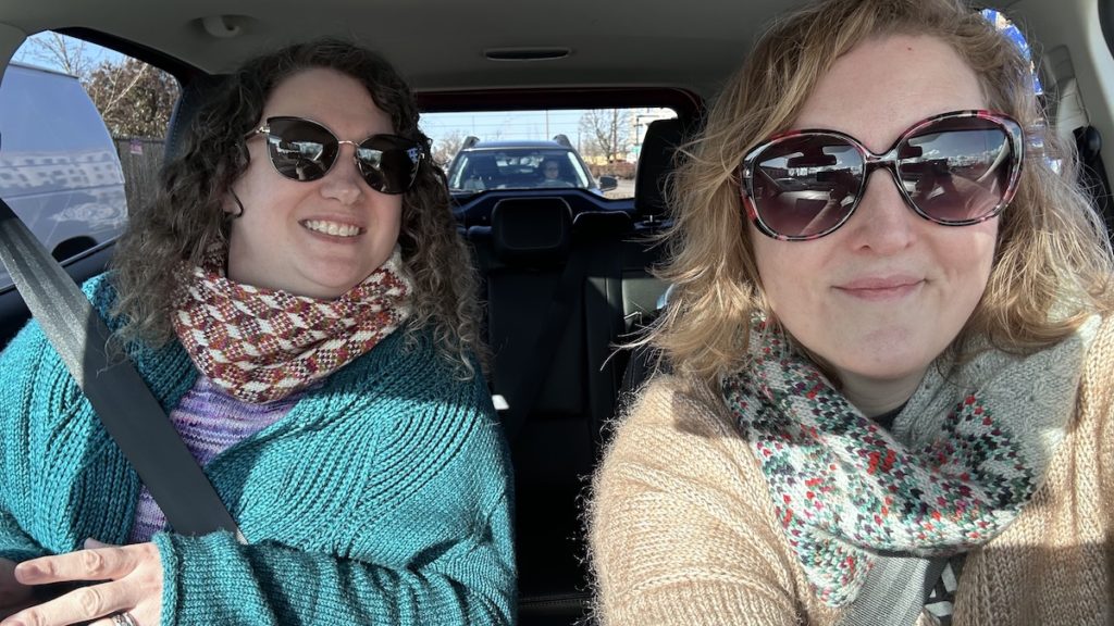 Andrea and me in a car, wearing our Oregon themed cowls